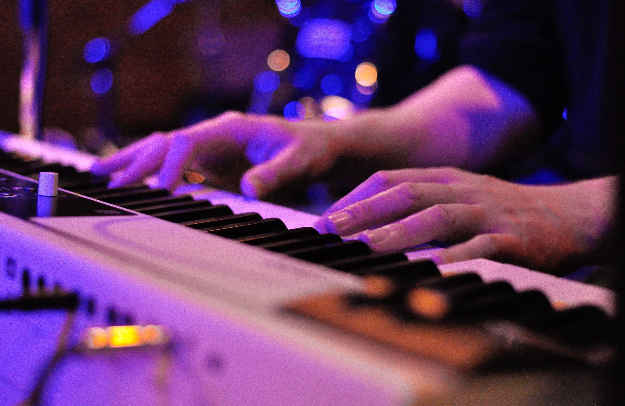 hands playing an electronic keyboard